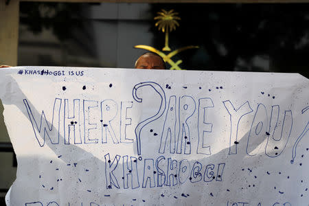 An Indonesian journalist holds a placard during a protest over the disappearance of Saudi journalist Jamal Khashoggi in front of the Saudi Arabia embassy in Jakarta, Indonesia, October 19, 2018. REUTERS/Beawiharta