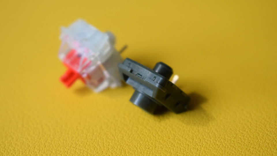 Photograph of Kailh Ghost low-profile linear mechanical switch next to Cherry MX2A silent red switch.