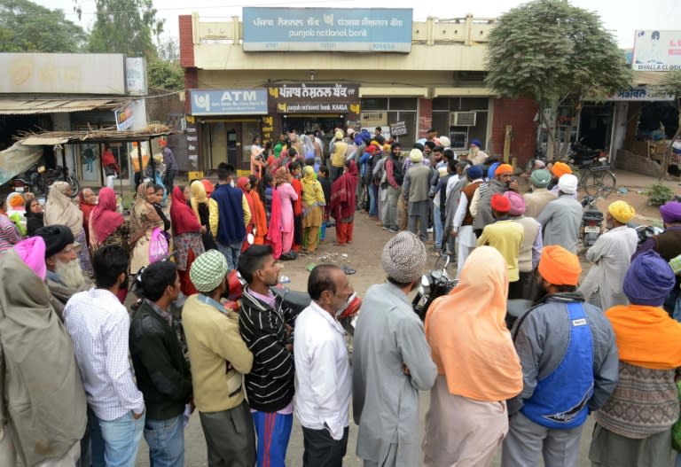 Villagers queue outside a bank in Khasa village, some 20kms from Amritsar, northwest India, as they wait to deposit and exchange 500 and 1000 rupees on November 12, 2016