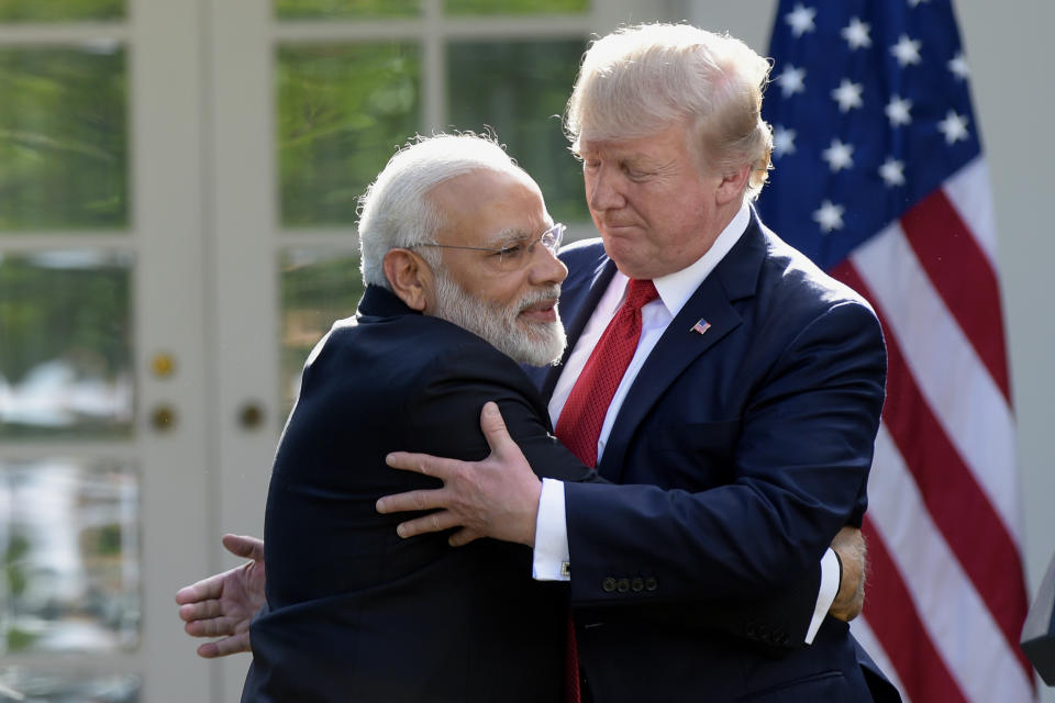 FILE - In this June 26, 2017 file photo, U.S. President Donald Trump and Indian Prime Minister Narendra Modi, left, hug while making statements in the Rose Garden of the White House in Washington. Indian Prime Minister Narendra Modi's party claimed it had won re-election with a commanding lead in vote count Thursday, May 23, 2019. Like President Donald Trump, to whom he is often compared, Modi is a big fan of Twitter and uses a YouTube channel to bypass traditional media. (AP Photo/Susan Walsh, File)