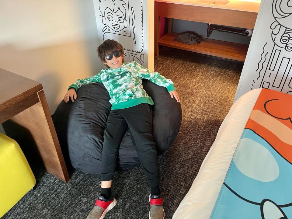 amanda adlers son sitting in beanbag chair at Cartoon Network Hotel