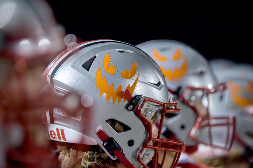 A jack-o'-lantern face adorns the helmets of the Morton Potters as they battle Metamora in a Week 4 football game Friday, Sept. 15, 2023 in Morton. The Potters downed the Redbirds 45-19.