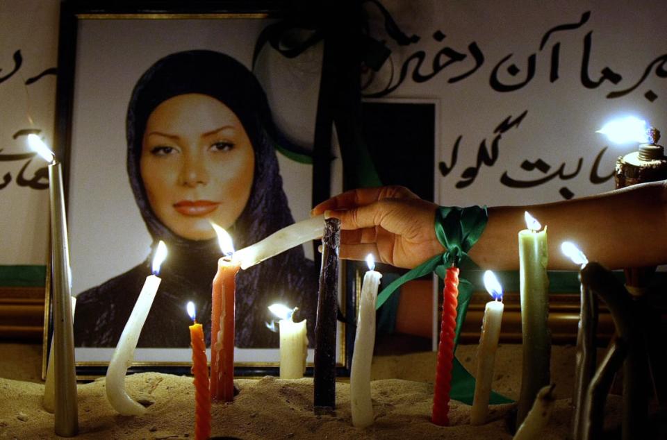 <div class="inline-image__caption"><p>A person lights a candle in front of a picture of Neda Agha-Soltan, a young Iranian woman whose death during protests in Iran made her a symbol for the opposition, during a vigil in Dubai on June 25, 2009.</p></div> <div class="inline-image__credit">Marwan Naamani/AFP via Getty</div>