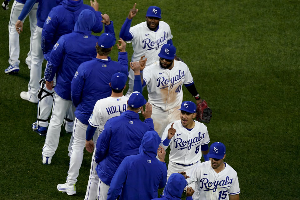 Kansas City Royals players celebrate after a baseball game against the Texas Rangers on Thursday, April 1, 2021, in Kansas City, Mo. The Royals won 14-10. (AP Photo/Charlie Riedel)