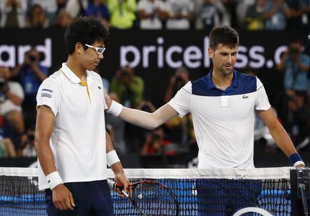 Tennis - Australian Open - Rod Laver Arena, Melbourne, Australia, January 22, 2018. South Korea's Chung Hyeon with Serbia's Novak Djokovic after Chung Hyeon wins the match. REUTERS/Edgar Su