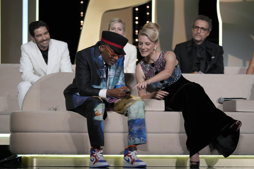 Jury president Spike Lee, bottom left, almost announces 'Titane' as the winner of the Palme d'Or for the second time as fellow jury members Tahar Rahim, from back left, Jessica Hausner, Kleber Mendonca Filho and Melanie Laurent, bottom right, look on during the awards ceremony at the 74th international film festival, Cannes, southern France, Saturday, July 17, 2021. (AP Photo/Vadim Ghirda)