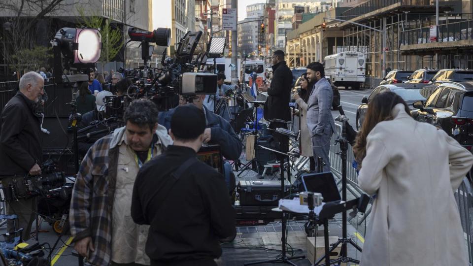 Members of the media gather outside Manhattan Criminal Court