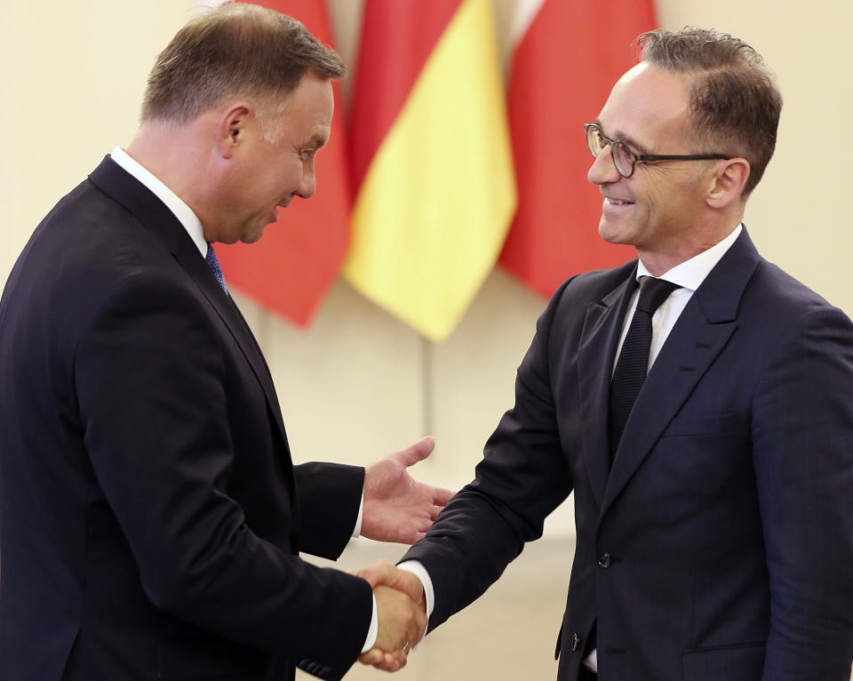 Poland's President Andrzej Duda, left, greets German Foreign Minister Heiko Maas on a two-day visit to Poland for political talks and for the Sept. 1 anniversary observances of World War II Warsaw Rising of 1944, in Warsaw, Poland, Wednesday, July 31, 2019. (AP Photo/Czarek Sokolowski)