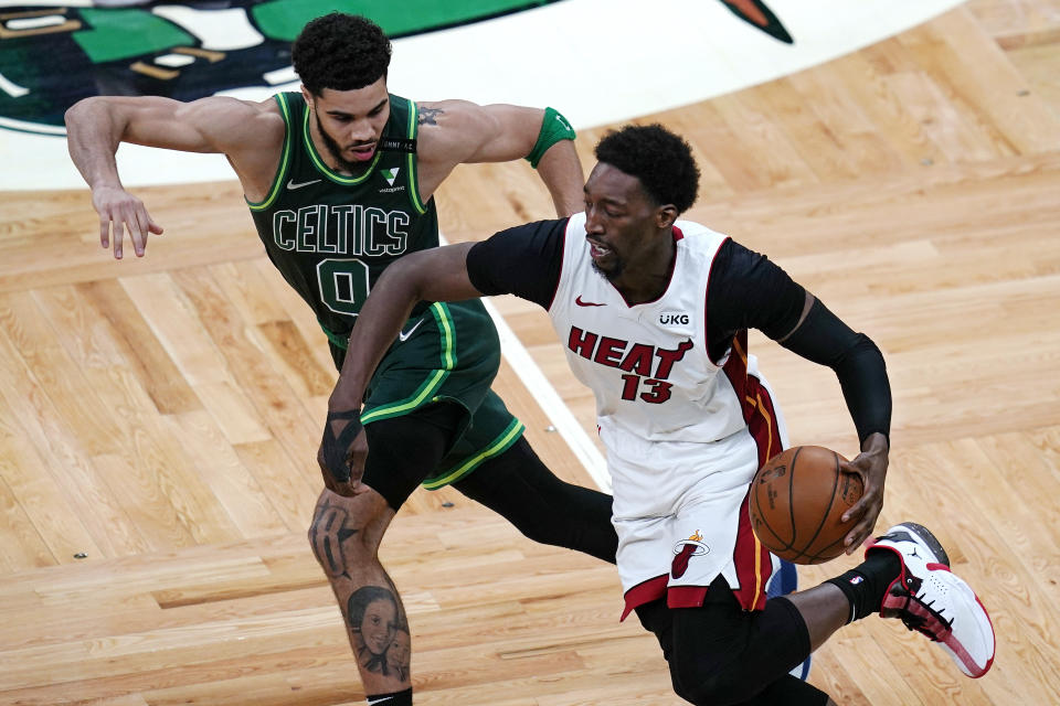 Miami Heat center Bam Adebayo (13) tries to outrun Boston Celtics forward Jayson Tatum (0) on a drive to the basket during the second half of an NBA basketball game Tuesday, May 11, 2021, in Boston. (AP Photo/Charles Krupa)