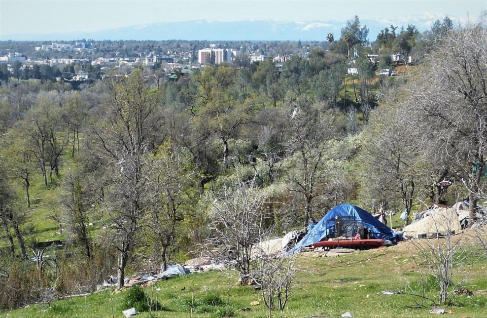 Downtown Redding, with homeless camps in the foreground, is seen from the Sulphur Creek Canyon on April 5, 2023.