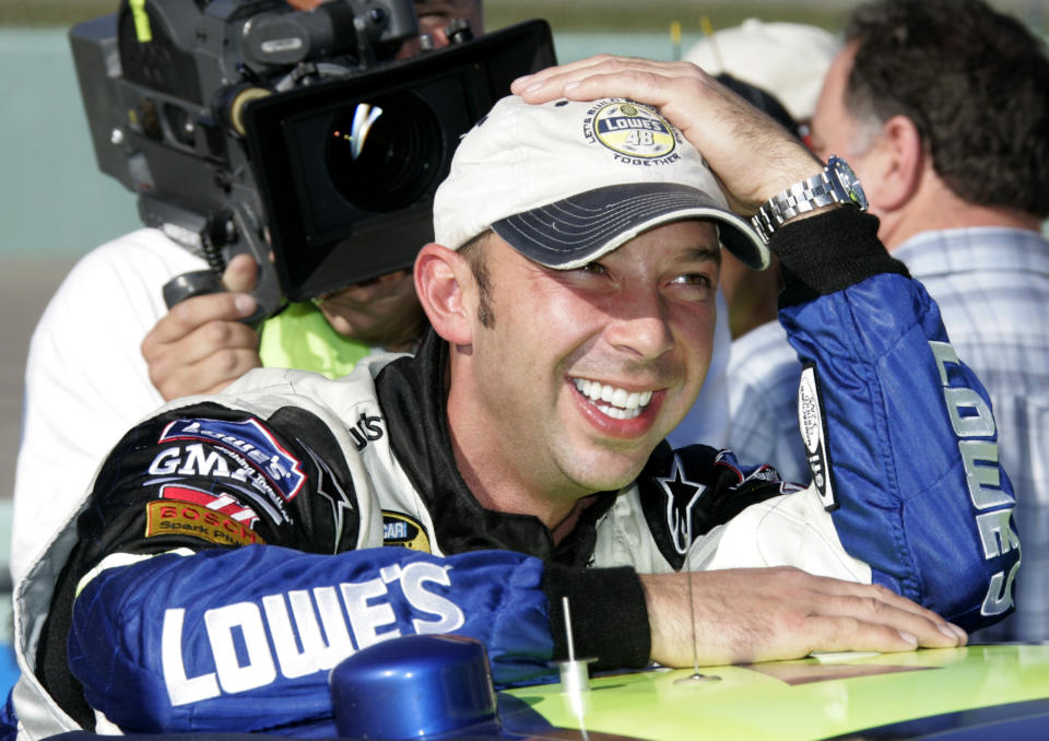 FILE - Crew chief Chad Knaus grins as he leans on the race car of NEXTEL Cup Series points leader Jimmie Johnson prior to the season finale Ford 400 auto race at Homestead-Miami Speedway in Homestead, Fla., Nov. 19, 2006. Jimmie Johnson and Chad Knaus will be feted together in Friday night’s NASCAR Hall of Fame ceremonies. (AP Photo/Terry Renna, File)