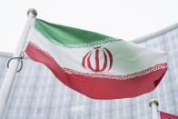 FILE - the flag of Iran waves in front of the the International Center building with the headquarters of the International Atomic Energy Agency, IAEA, in Vienna, Austria, Monday, May 24, 2021. Iran and world powers resume talks in Vienna this week of Nov. 28, 2021, aimed at restoring the nuclear deal that crumbled after the U.S. pulled out three years ago. There are major doubts over whether the deal can be reinstated after years of mounting distrust. (AP Photo/Florian Schroetter, FILE)