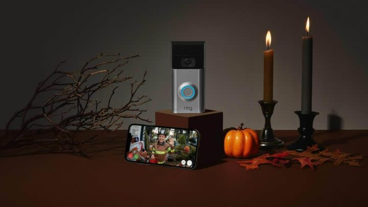 A Ring Video Doorbell next to Halloween decorations.
