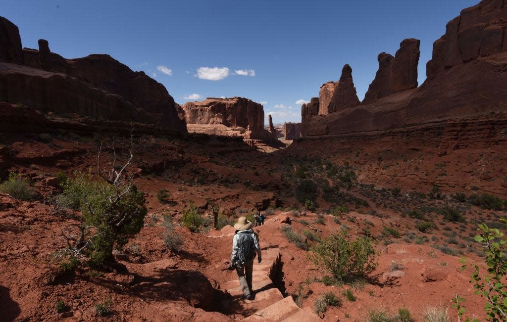 Hikers make their way along Park Avenue trail in Arches National Park near Moab, Utah, on April 21, 2018.