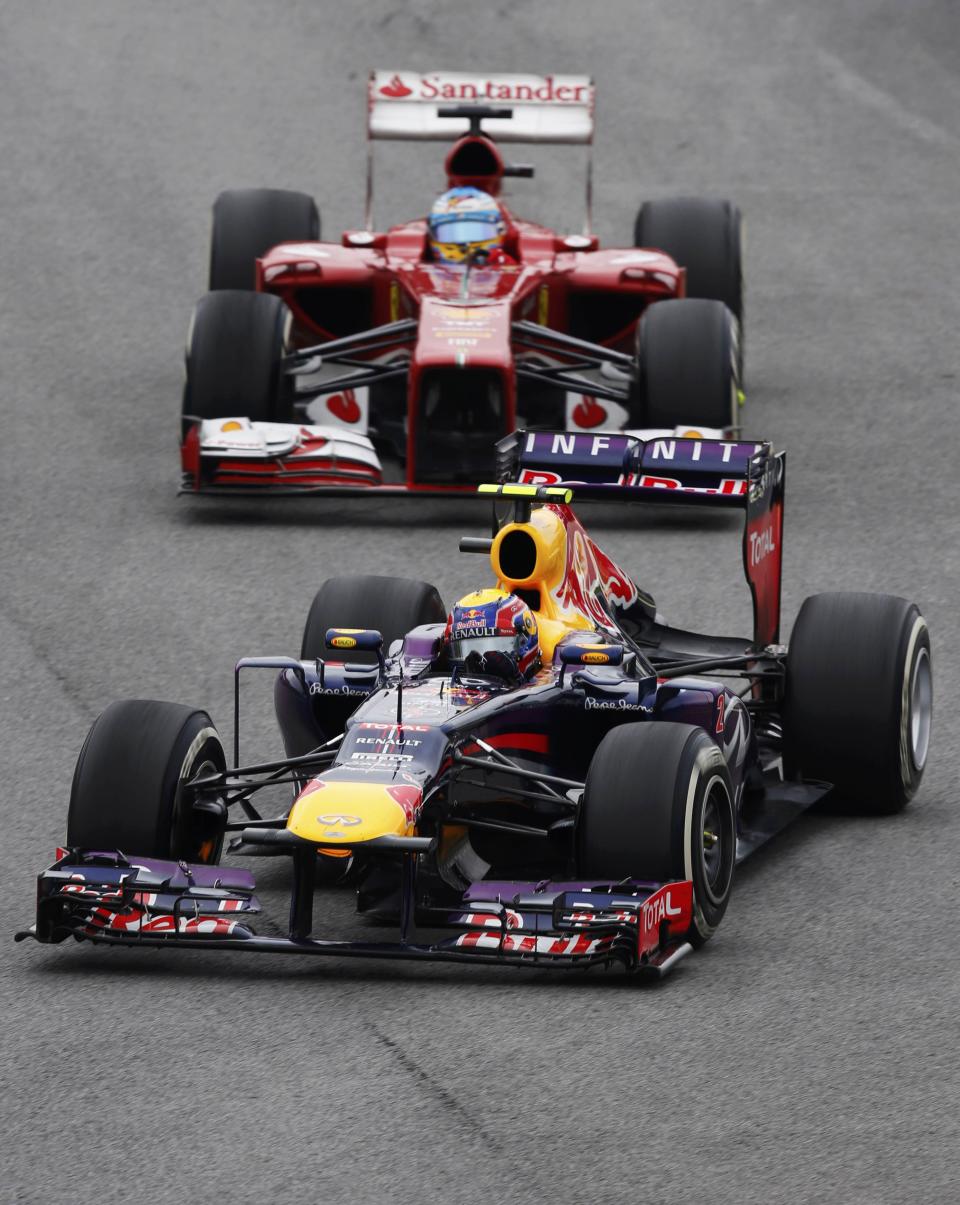 Mark Webber of Australia drives ahead of Fernando Alonso of Spain during the Brazilian F1 Grand Prix at the Interlagos circuit in Sao Paulo