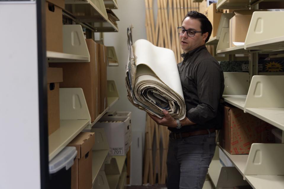 David Mindel, digital collections librarian at UW-La Crosse's Murphy Library, moves materials belonging to the library's new Driftless River Initiative, which will chronicle the historical, cultural and scientific stories of the upper Mississippi River region.