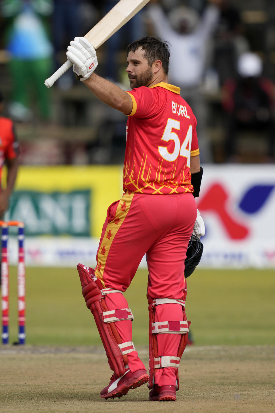 Zimbabwe's batsman Ryan Burl celebrates after scoring 50 runs on the final day of the T20 match between Zimbabwe and Bangladesh at Harare Sports Club in Harare, Zimbabwe, Tuesday, Aug. 2, 2022. (AP Photo/Tsvangirayi Mukwazhi)