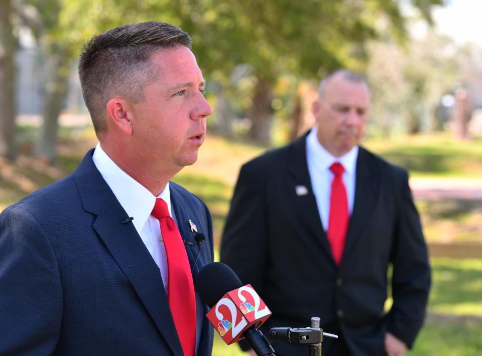 District 2 County Commission candidate Chris Hattaway (foreground) and District 2 School Board candidate Shawn Overdorf met with the media Friday morning to discuss the sheriff's phone call and alleged job offers.