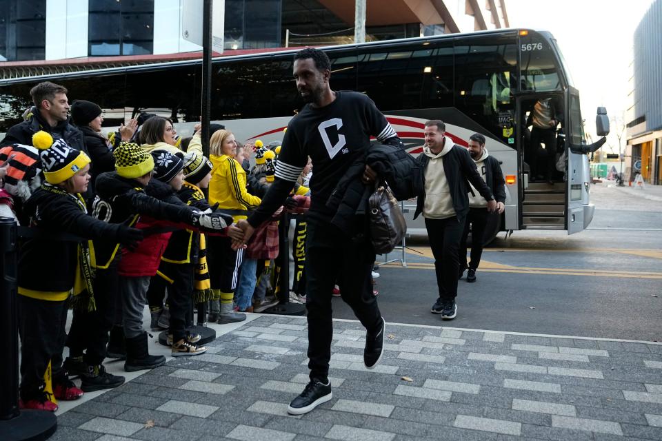 Crew coach Wilfried Nancy high fives fans as he arrives at Lower.com Field for the first round of the MLS Cup Playoffs against Atlanta United.