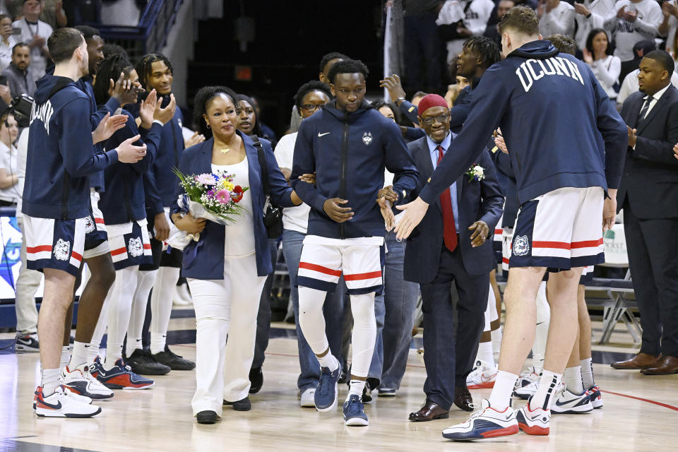 UConn guard Hassan Diarra, center is introduced with his family for senior ceremonies before ian NCAA college basketball game, Sunday, March 3, 2024, in Storrs, Conn. (AP Photo/Jessica Hill)