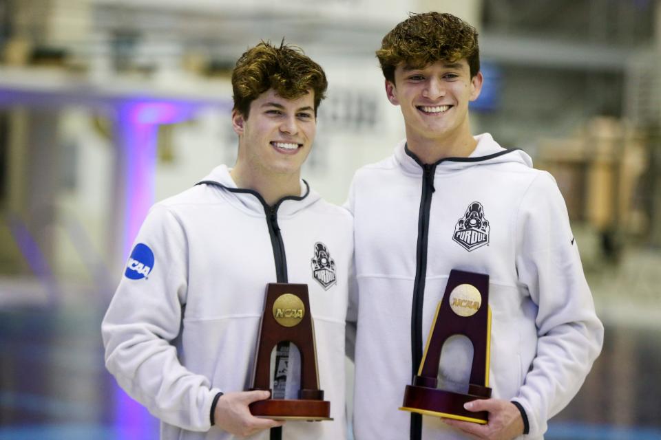 Mar 26, 2022; Atlanta, GA, USA; Purdue Boilermakers diver Jordan Rzepka and diver Tyler Downs celebrate after finishing seventh and first at the NCAA Mens Swimming & Diving Championships at McAuley Aquatic Center. Mandatory Credit: Brett Davis-USA TODAY Sports