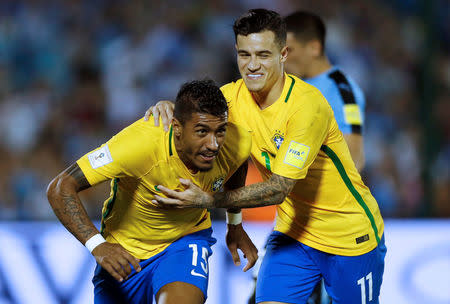 Football Soccer - Uruguay v Brazil - World Cup 2018 Qualifiers - Centenario stadium, Montevideo, Uruguay - 23/3/17 - Brazil's Paulinho (L) celebrates his second goal with teammate Phillipe Coutinho. REUTERS/Andres Stapff