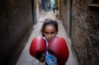 Jessica , 9, poses for a photograph in an alley, also known as "viela", in the Mare favela of Rio de Janeiro, Brazil, June 2, 2016. REUTERS/Nacho Doce