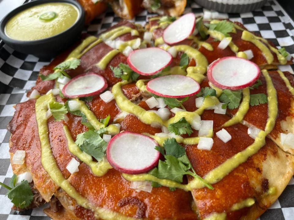 Taco Vibe’s birria Mexican pizza, a cheese-crusted birria quesadilla dressed with jalapeno sauce, is a must-try if you visit them in Saginaw.