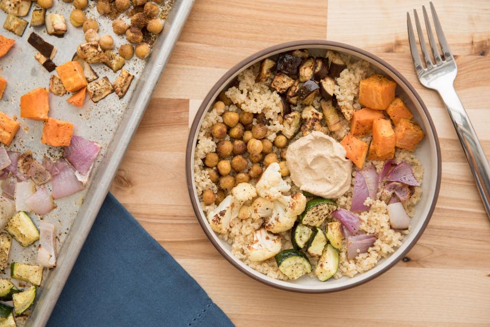 Moroccan Sheet-Pan Buddha Bowl calls for a mix of vegetables that includes sweet potatoes, chickpeas and eggplalnt.