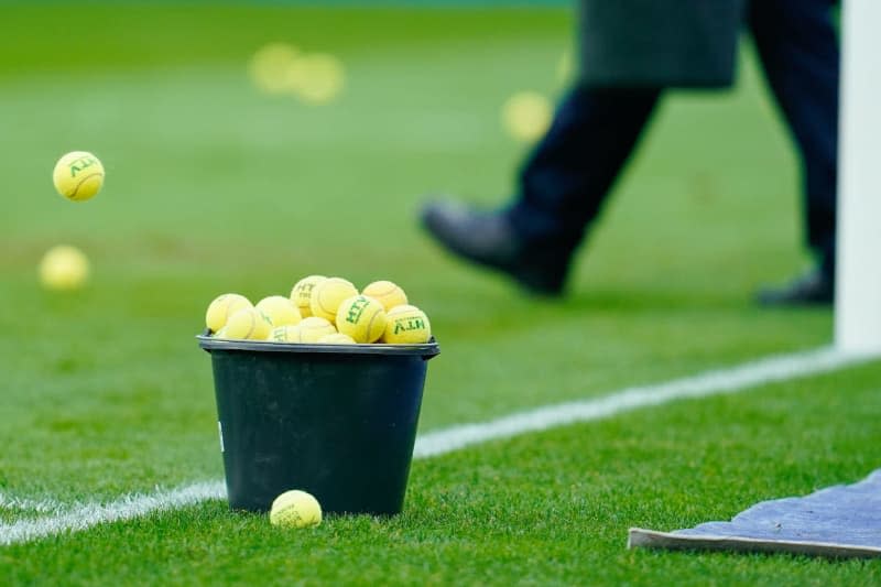 A bucket of collected tennis balls stands on the edge of the pitch, after they were thrown by spectators in protest against the German Football League's (DFL) plans to bring in investors, during the German Bundesliga soccer match between SV Darmstadt 98 and VfB Stuttgart at the Merck-Stadion am Boellenfalltor. Uwe Anspach/dpa