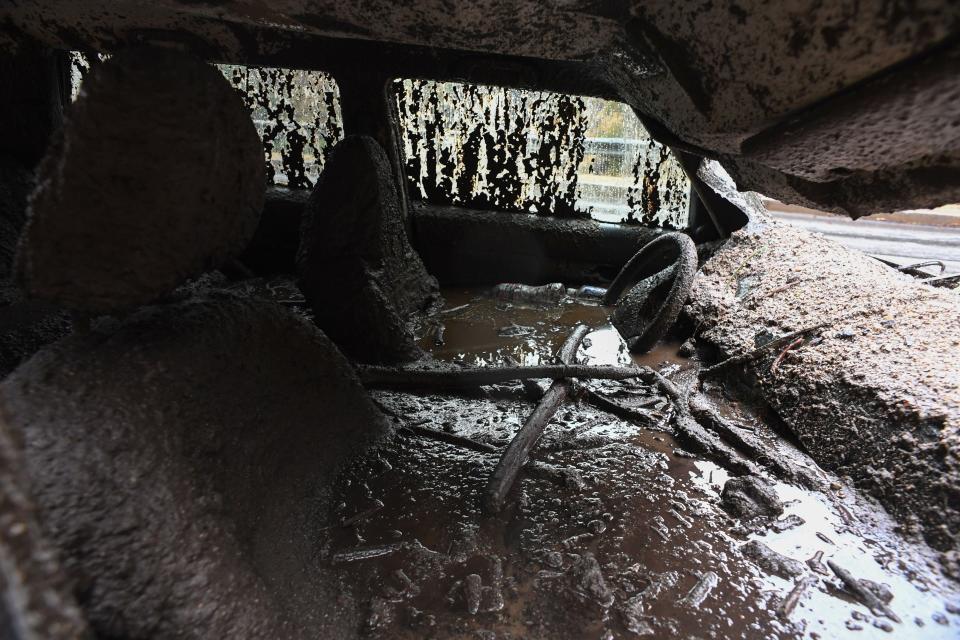 Mud filled the interior of a car destroyed in Burbank.