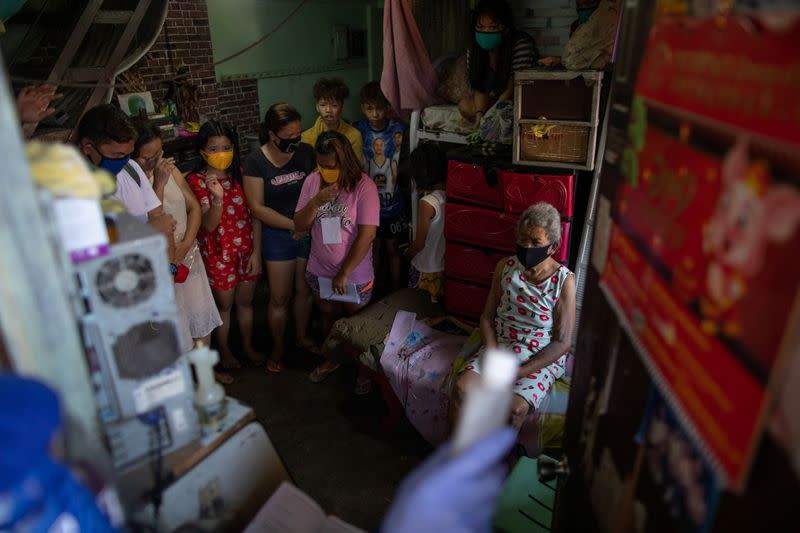 The Wider Image: Hazmat suits and holy water: two priests bring faith to Philippines lockdown