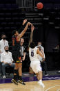 Maryland guard Aaron Wiggins, left, shoots over Northwestern guard Boo Buie during the second half of an NCAA college basketball game in Evanston, Ill., Wednesday, March 3, 2021. Northwestern won 60-55.(AP Photo/Nam Y. Huh)