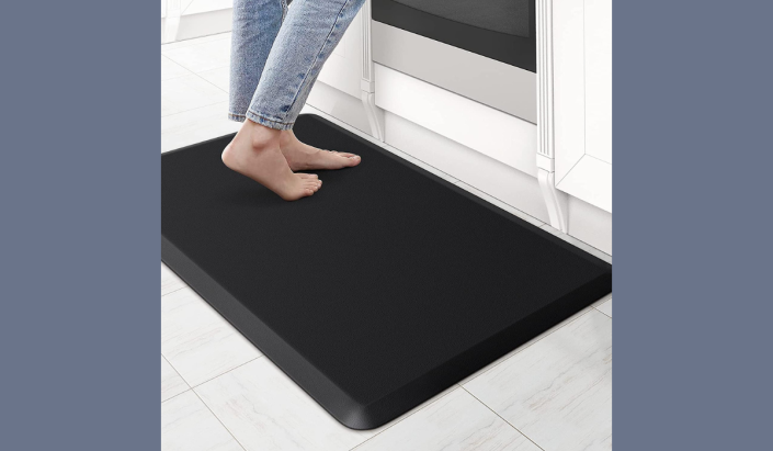 woman standing on kitchen floor mat