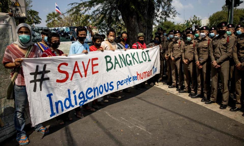 Protesters hold a “Save Bangkloi” banner in front of a line of police officers during a land rights demonstration held by members of the Karen