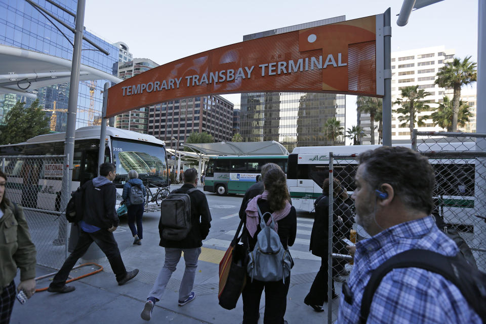 Commuters make their way into the Temporary Transbay Terminal after the Salesforce Transit Center was closed Tuesday, Sept. 25, 2018, in San Francisco. San Francisco officials shut down the city's celebrated new $2.2 billion transit terminal Tuesday after discovering a crack in a support beam under the center's public roof garden. Coined the "Grand Central of the West," the Salesforce Transit Center opened in August near the heart of downtown after nearly a decade of construction. It was expected to accommodate 100,000 passengers each weekday, and up to 45 million people a year. (AP Photo/Eric Risberg)