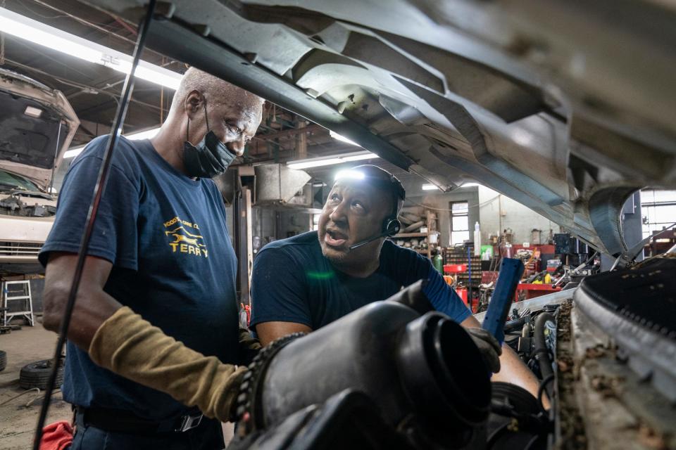 Terry Lucas, of Warren, left works with Earl "Butch" Hood Jr. at Hood's Car Care Clinic in Detroit Friday, June 24, 2022 as they work on a van to replace an alternator.