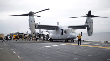 FILE PHOTO: Participants in a ceremony marking the start of Talisman Saber 2017, a biennial joint military exercise between the United States and Australia, board a U.S. Marines MV-22B Osprey Aircraft on the deck of the USS Bonhomme Richard amphibious assault ship off the coast of Sydney, Australia, June 29, 2017. REUTERS/Jason Reed/File Photo