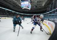 Colorado Avalanche center Carl Soderberg (34) moves the puck past San Jose Sharks defenseman Nicolas Meloche (53) during the second period of an NHL hockey game in San Jose, Calif., on Wednesday, May 5, 2021. (AP Photo/Tony Avelar)