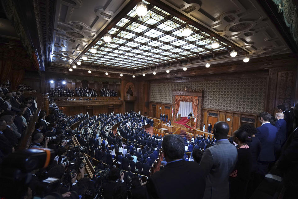 Japan's Emperor Naruhito, seated right, attends the opening of an extraordinary session at the upper house of parliament in Tokyo Friday, Oct. 4, 2019. (AP Photo/Eugene Hoshiko)