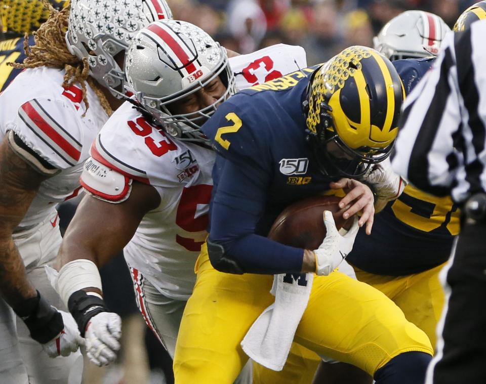 Ohio State defensive tackle Davon Hamilton (53) sacks Michigan quarterback Shea Patterson (2) during their November 2019 game.