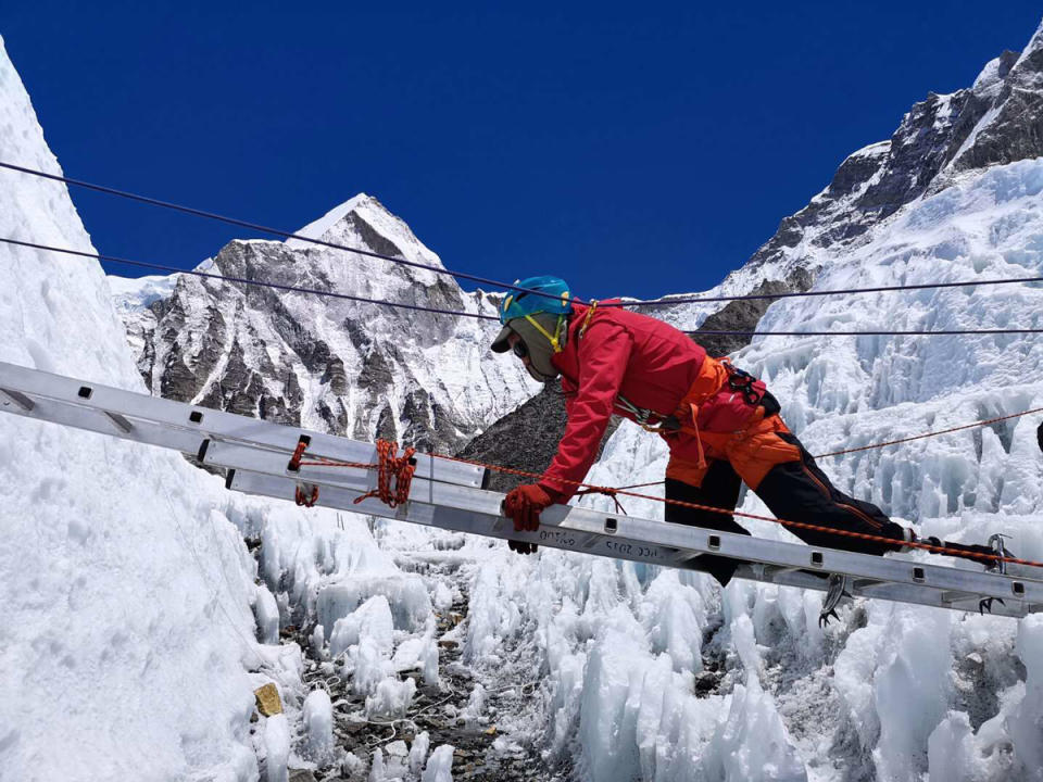 Xia Boyu crosses a ladder in the Khumbu Icefall in May.