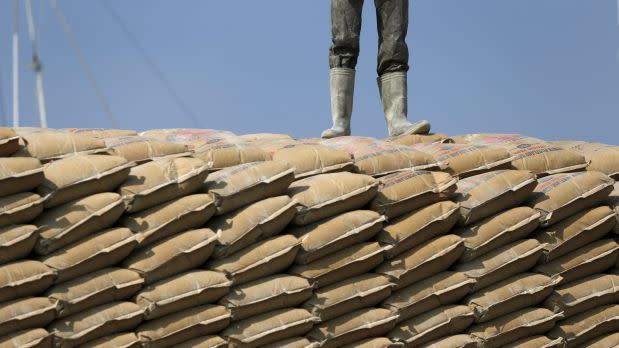 A worker stands on sacks of cement at Sunda Kelapa harbor in Jakarta