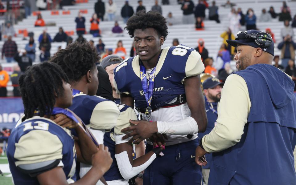 Newburgh's Deondre Johnson (81) consoles teammates after Bennett defeated Newburgh in the state Class AA football championship at JMA Wireless Dome in Syracuse Dec. 4, 2022. 