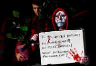 FILE PHOTO: A climate activist holds a sign during a protest in front of EU Commission headquarters in Brussels