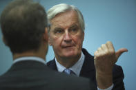 European Union chief Brexit negotiator Michel Barnier, right, speaks as he attends the weekly EU College of Commissioners meeting at EU headquarters in Brussels, Wednesday, Oct. 16, 2019. European Union and British negotiators have failed to get a breakthrough in the Brexit talks during a frantic all-night session and will continue seeking a compromise on the eve of Thursday's crucial EU summit. (AP Photo/Francisco Seco)