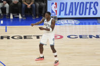 Minnesota Timberwolves guard Anthony Edwards (5) celebrates after a basket made by guard Nickeil Alexander-Walker during the second half of Game 2 of an NBA basketball first-round playoff series against the Phoenix Suns, Tuesday, April 23, 2024, in Minneapolis. (AP Photo/Abbie Parr)