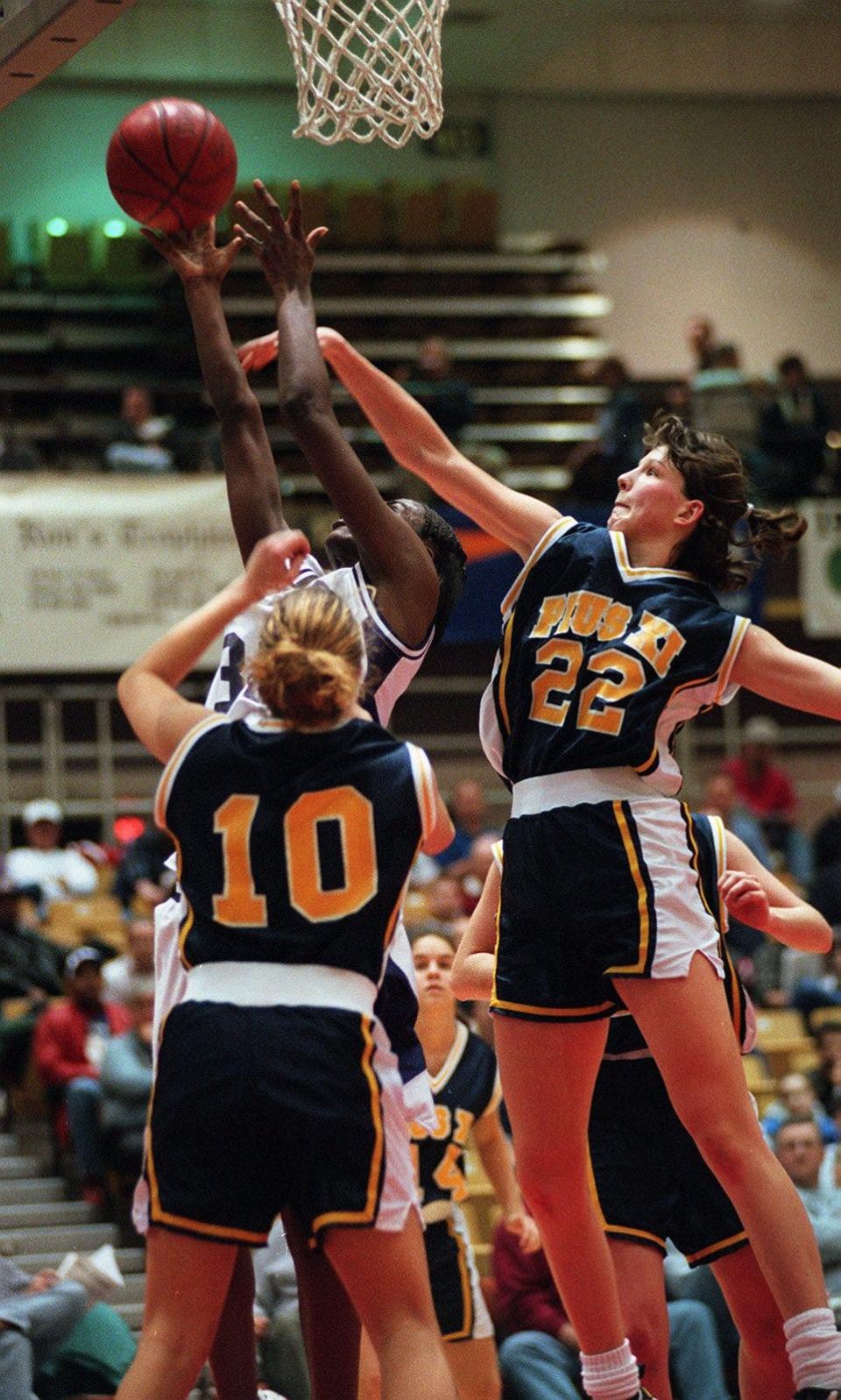 Zuzana Klimešová (No. 22) soars in for a rebound for Pius XI at a showcase in Columbus, Ohio, in 1998.