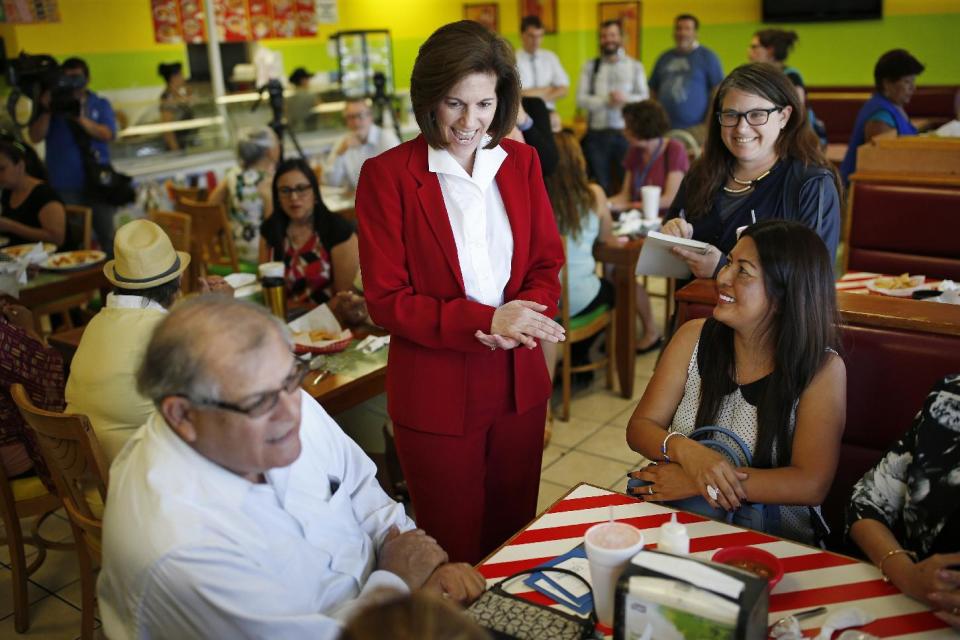 Senate candidate Catherine Cortez Masto, center, laughs while speaking with people at a campaign event in Las Vegas. (Photo: John Locher/AP)