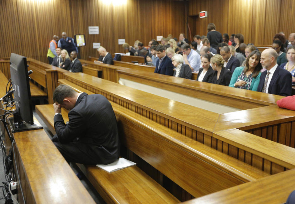 Oscar Pistorius sits in the dock on the second day of his trial at the high court in Pretoria, South Africa, Tuesday, March 4, 2014. Pistorius is charged with murder for the shooting death of his girlfriend, Reeva Steenkamp, on Valentines Day in 2013. (AP Photo/Kim Ludbrook, Pool)